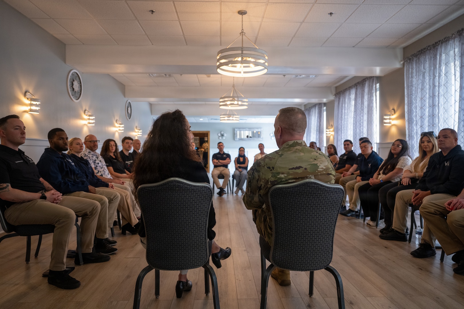 Chief Master Sgt. of the Air Force David Wolfe speaks with recruiters during a tour