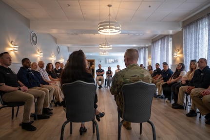 Chief Master Sgt. of the Air Force David Wolfe speaks with recruiters during a tour