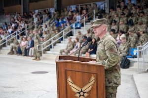 Chief Master Sergeant of the Air Force David R. Wolfe addresses Airmen as the guest speaker during a coin and retreat ceremony at Joint Base San Antonio-Lackland.