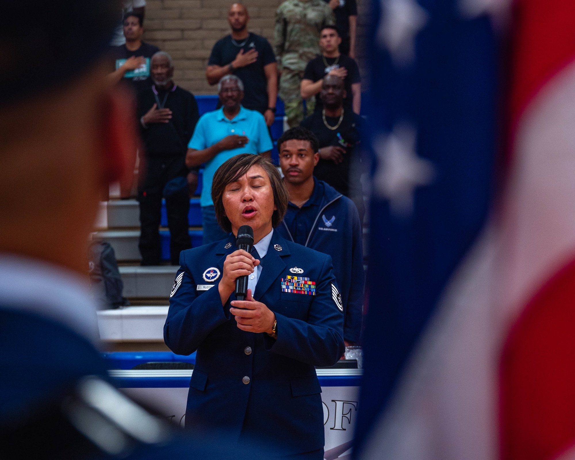 U.S. Air Force Tech Sgt. Carol Russell, 56th Maintenance Group F-35 integrated avionics journeyman, sings the national anthem, April 2, 2026, at Luke Air Force Base, Arizona.