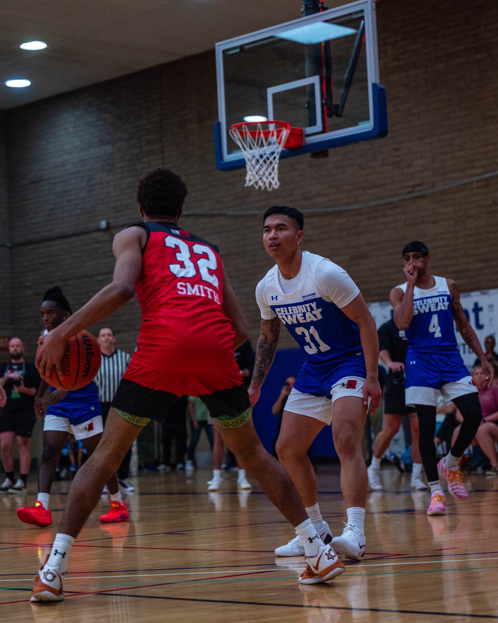 U.S. Air Force Senior Airman Eric Smith (left), 56th Equipment Management Squadron data analyst, and Senior Airman Vinchenzo Ortega (right), 56th Comptroller Squadron financial management accountant, participate in Celebrity Slam Jam, April 2, 2026, at Luke Air Force Base, Arizona.
