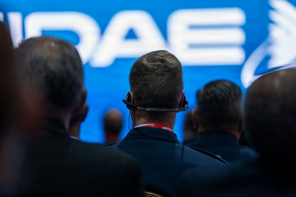 U.S. Air Force Maj. Gen. David Minaeu, commander of Air Forces Southern, listens during the opening ceremony of the Feria Internacional del Aire y del Espacio (FIDAE) 2026 in Santiago, Chile, April 7, 2026. Real-time translation headsets enabled English-speaking attendees like Minaeu to follow the Spanish-language ceremony and ensured collaboration and understanding across cultures. (U.S. Air Force photo by Andrea Jenkins)