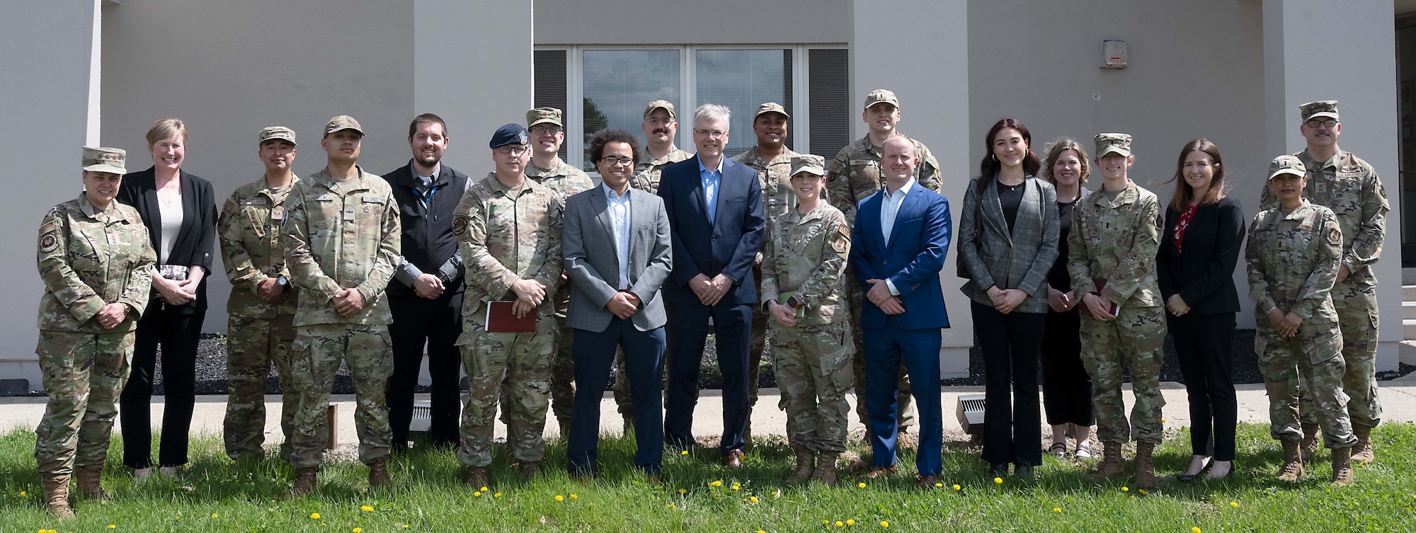 group photo in front of brick building