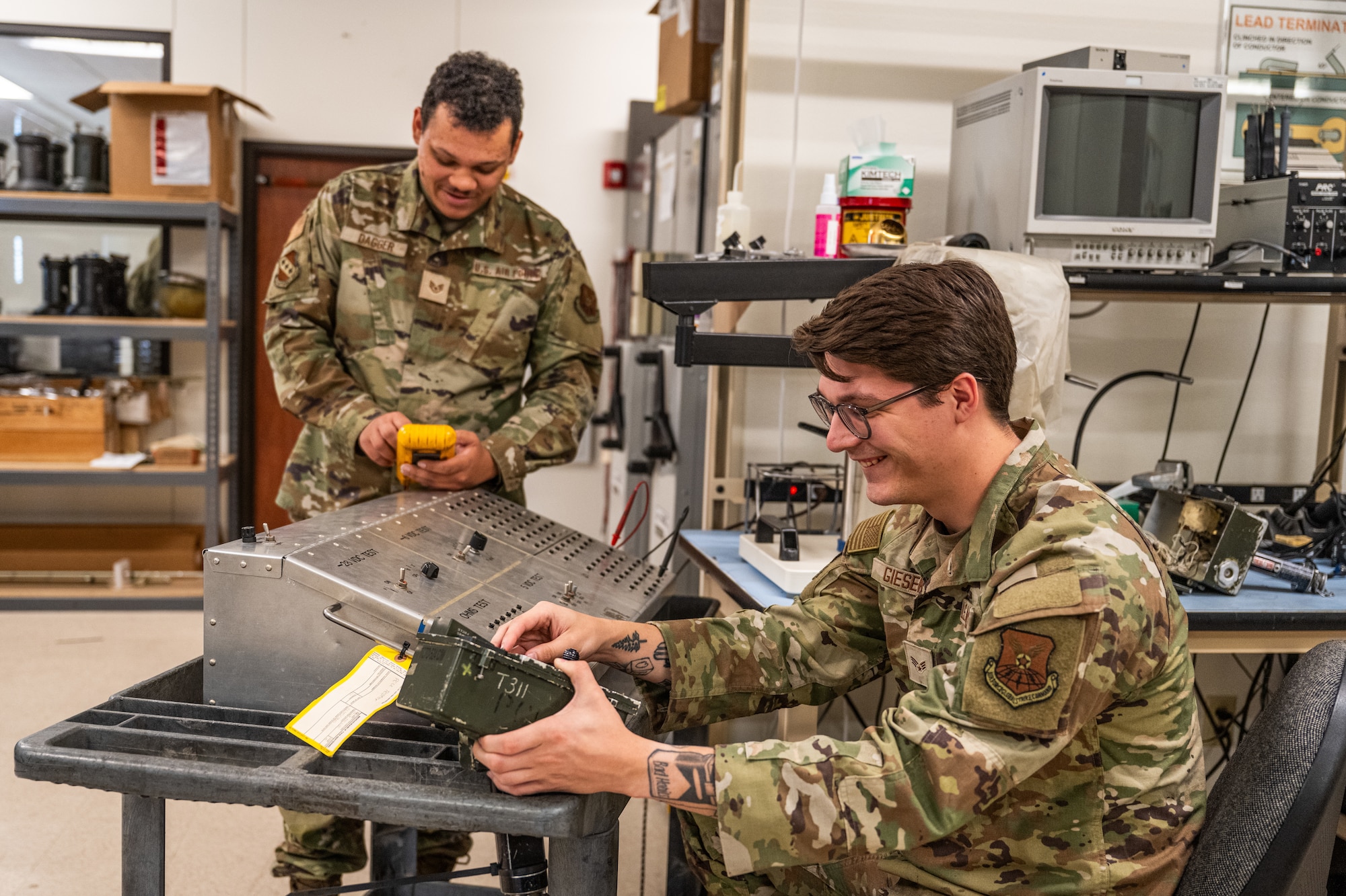 From left, U.S. Air Force Staff Sgt. James Dagger and Senior Airman Kole Gieseke, both 7th Maintenance Group Air Force Repair Enhancement Program technicians, test a munitions trailer controller at Dyess Air Force Base, Texas, March 23, 2026. By repairing small components within the controller, AFREP technicians can restore equipment valued at $130,000 for less than $100, increasing availability of assets no longer in production. (U.S. Air Force photo by Airman 1st Class Caleb Schellenberg)
