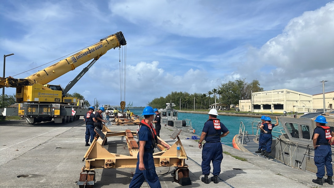 Members of the U.S. Coast Guard Station Apra Harbor prepare to pull 45-foot Response Boat-Mediums to cradle them against storm force winds and prevent damage on April 10, 2026, ahead of storm Sinlaku. The U.S. Coast Guard is coordinating with the National Weather Service, Guam Homeland Security/Office of Civil Defense, Commonwealth of the Northern Mariana Islands Office of Homeland Security and Emergency Management, and local and federal partners as part of a unified One Marianas response. (U.S. Coast Guard photo by Chief Petty Officer Kyle Breen-Tapia)