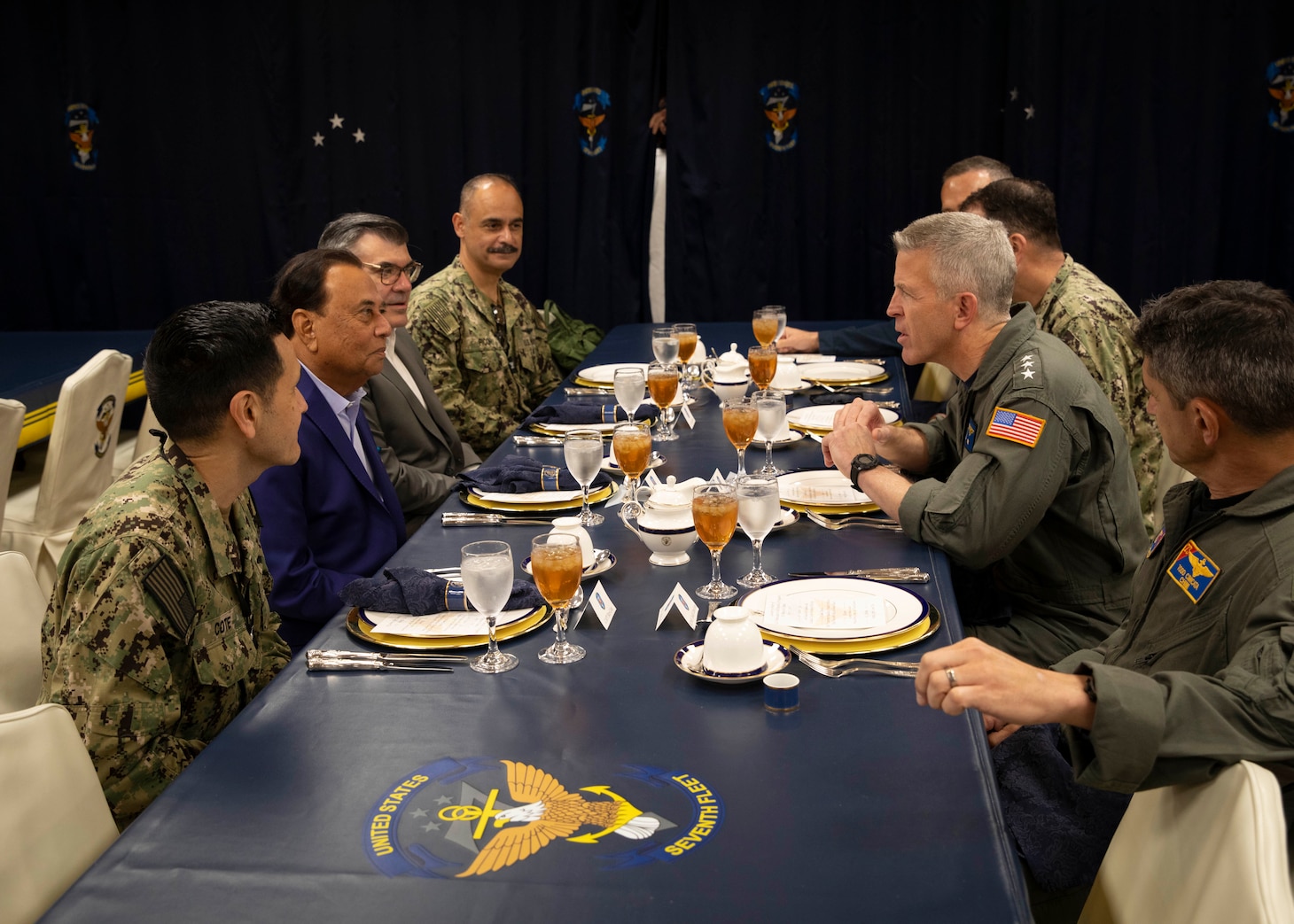 U.S. Ambassador to Singapore Dr. Anjani Sinha (left center left) and Deputy Chief of Mission Graham Mayer (left center right) meet with U.S. 7th Fleet Commander Vice Adm. Pat Hannifin aboard 7th Fleet flagship USS Blue Ridge (LCC 19) during a scheduled port visit to Singapore, April 7, 2026.