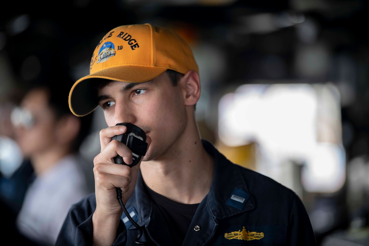 Lt. j.g. Nathaniel Panto stands officer of the deck watch in the pilot house wing aboard U.S. 7th Fleet flagship USS Blue Ridge (LCC 19) as the ship departs Changi, Singapore, April 10, 2026 following a scheduled port visit.
