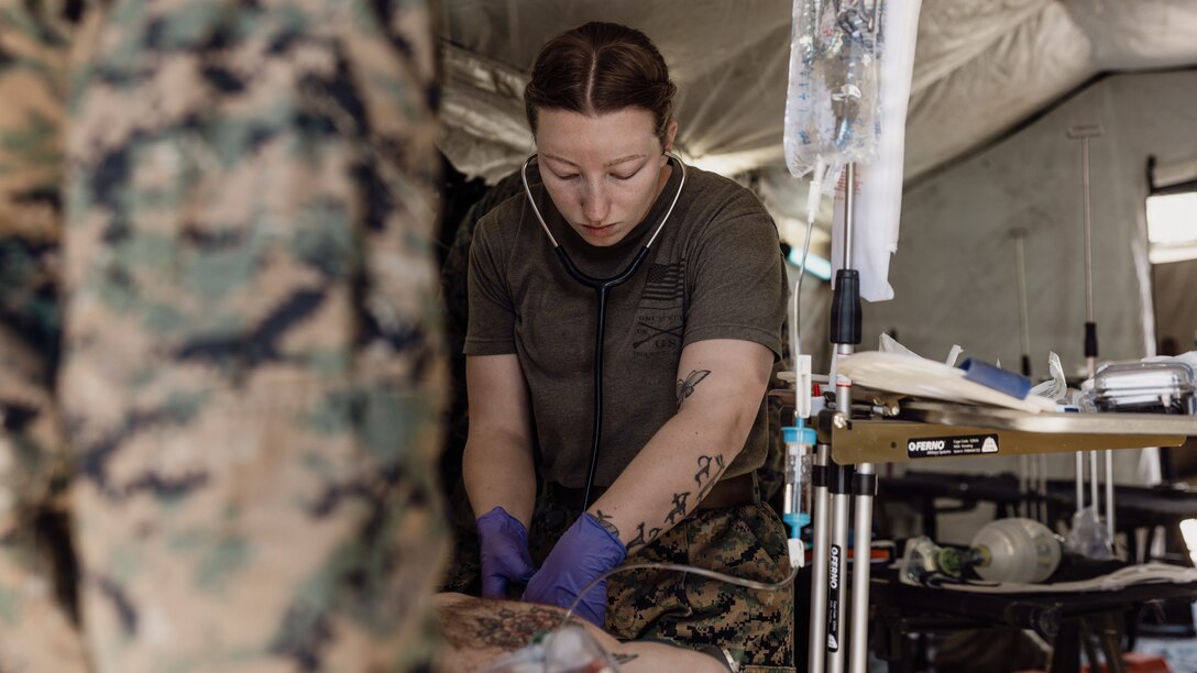 U.S. Navy Hospitalman 3rd Class. Kieri Hart, a Virginia native and a hospital corpsman with 2nd Combat Engineer Battalion, 2nd Marine Division, monitors heartrate on a simulated casualty during a simulated casualty evacuation as part of Mountain Warfare Training Exercise 2-26 on Marine Corps Mountain Warfare Training Center, Bridgeport, California, March 12, 2026. MTX is a one-month-long exercise designed to prepare units to survive and strengthen expeditionary warfare tactics in cold-weather mountainous environments. (U.S. Marine Corps photo illustration by Lance Cpl. Dominic Trujillo)