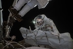 An astronaut waves during a spacewalk