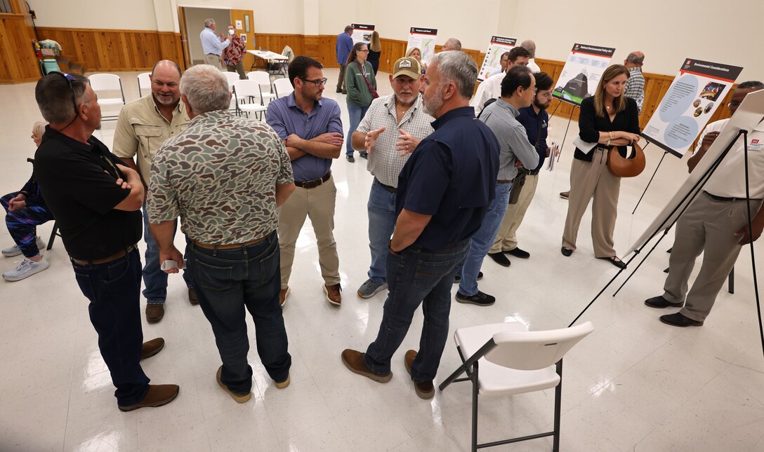People standing at a group meeting.