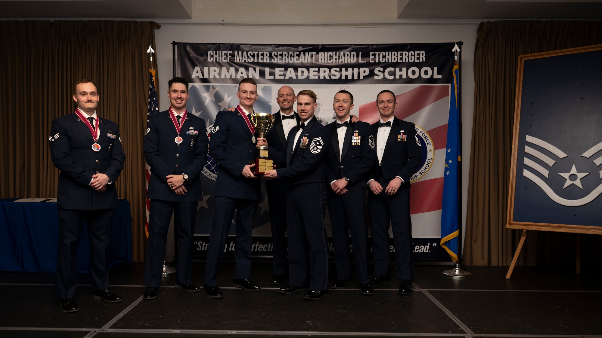 A photo of airmen posing with an award