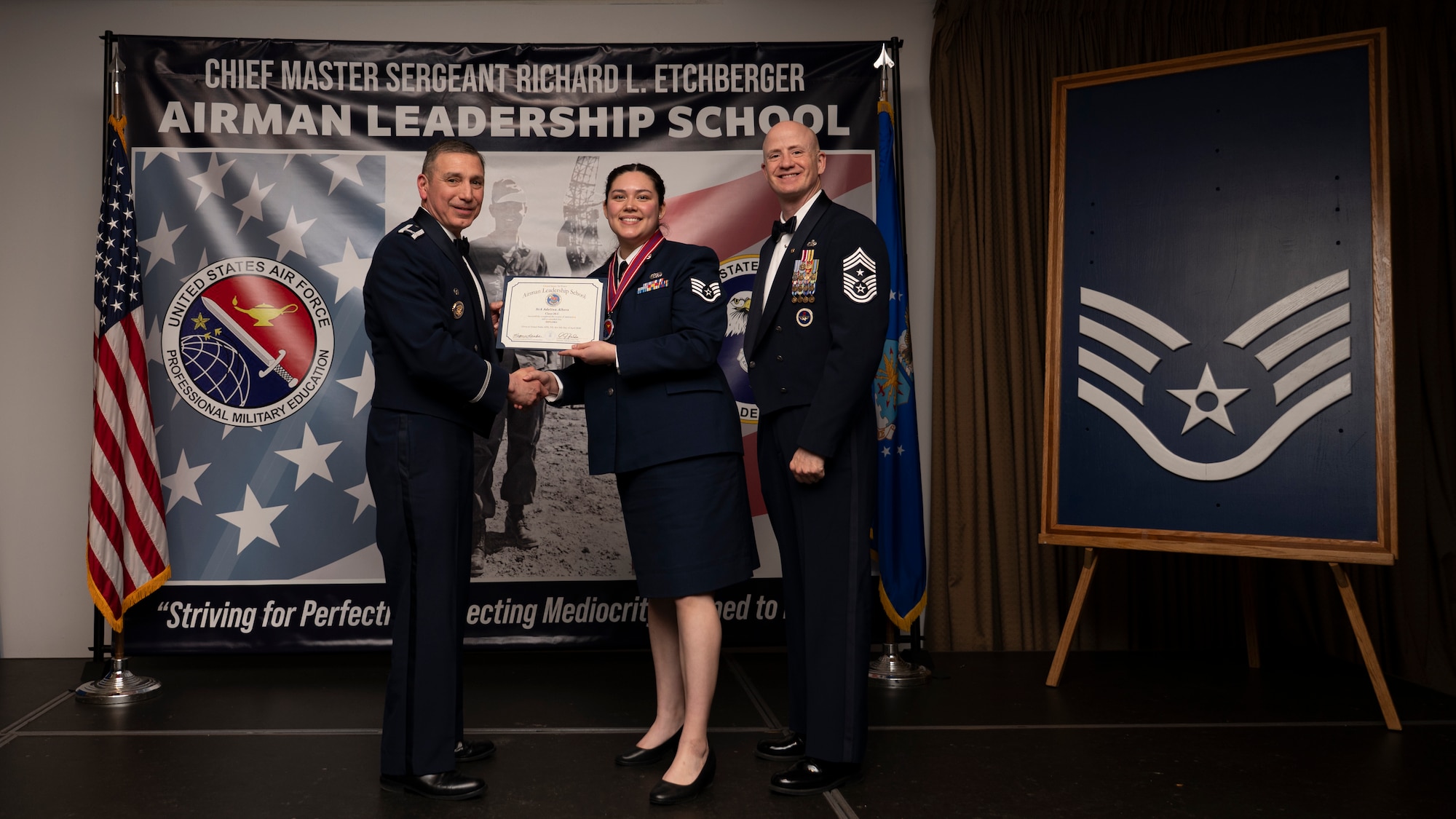 A photo of airmen posing with an award