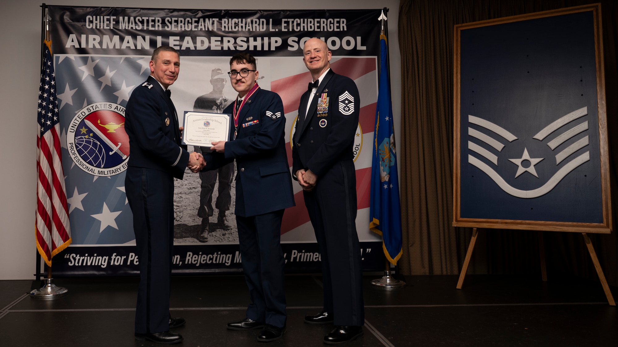 A photo of airmen posing with an award