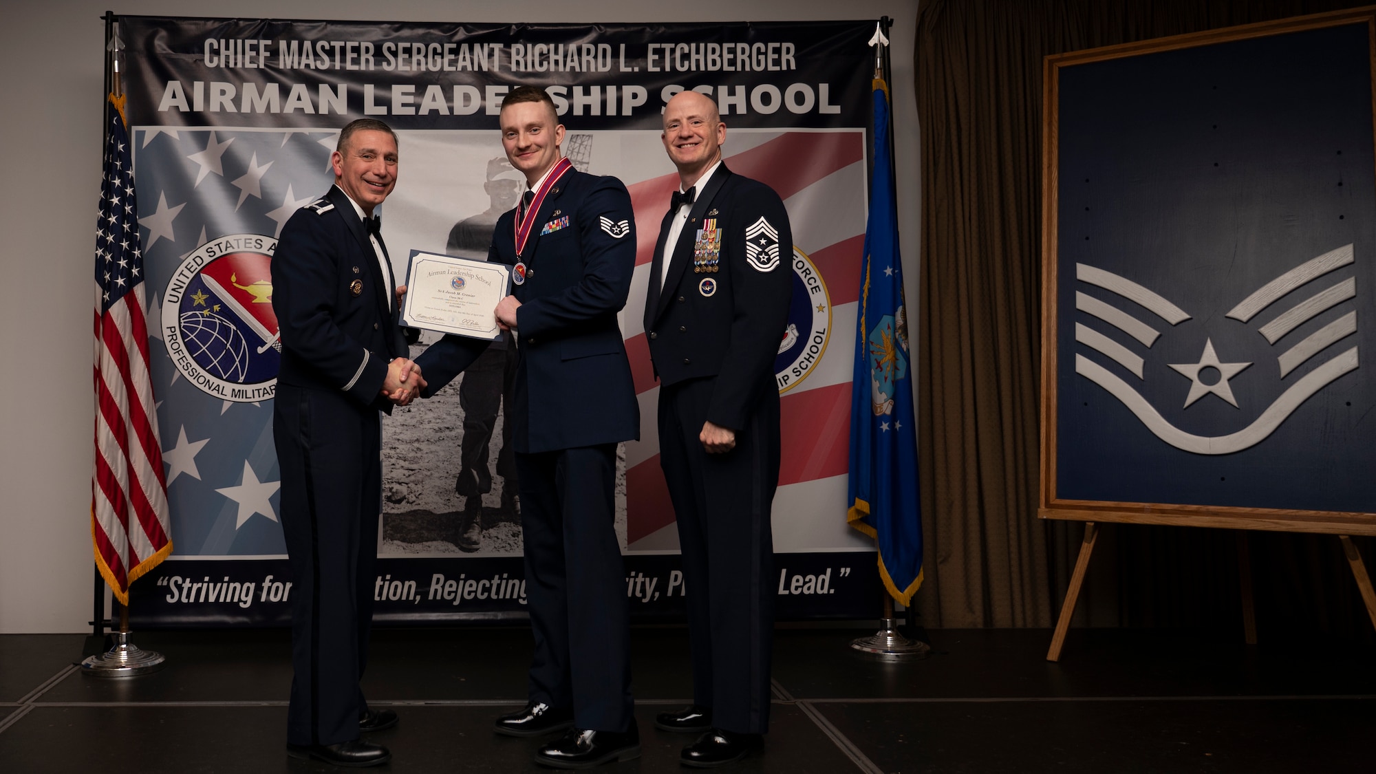 A photo of airmen posing with an award