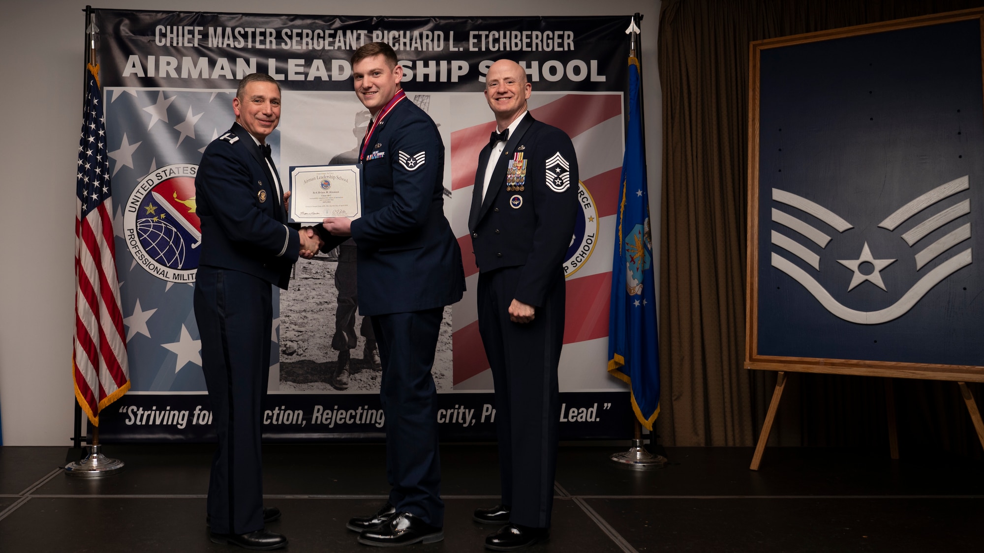 A photo of airmen posing with an award