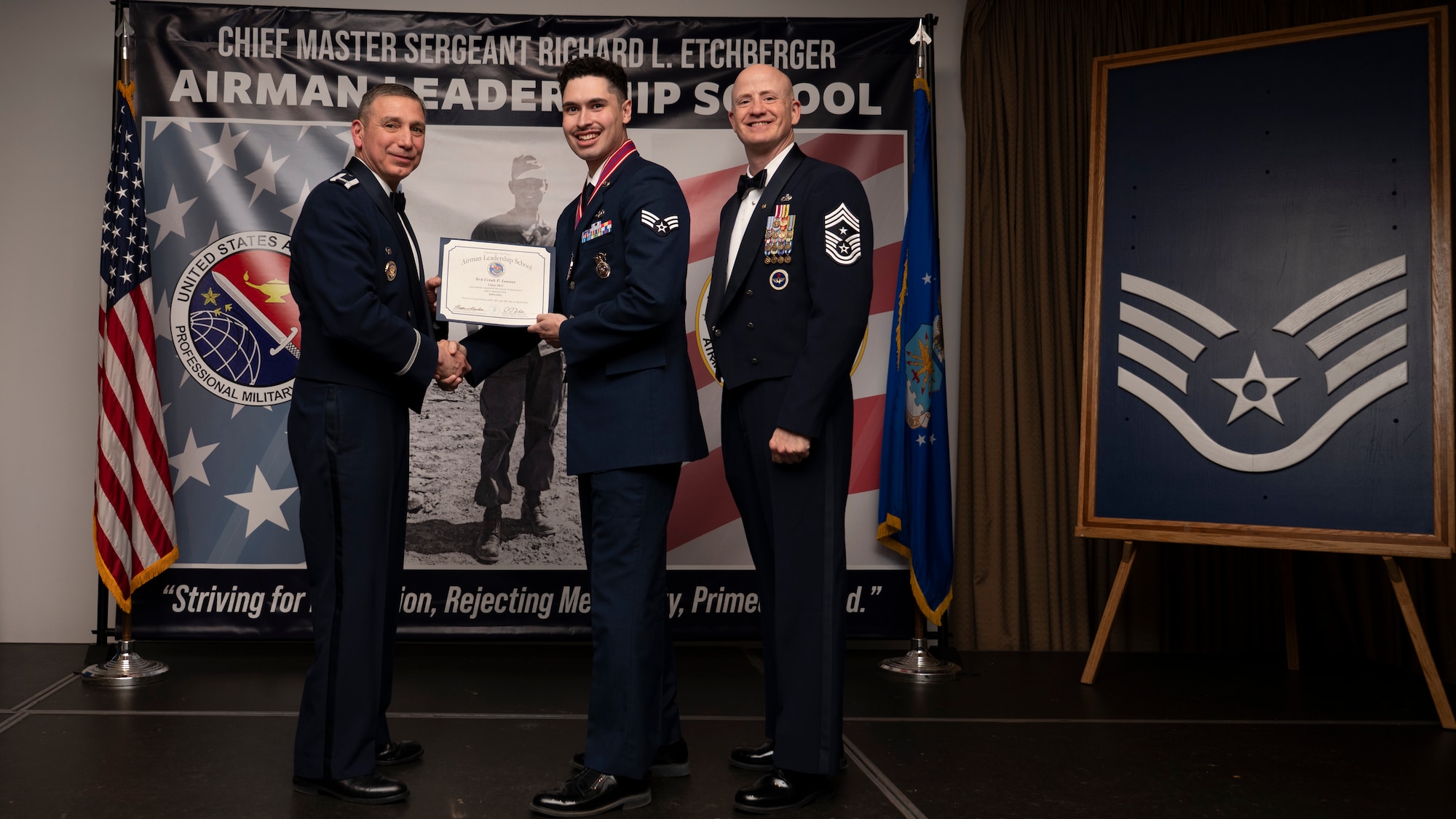 A photo of airmen posing with an award