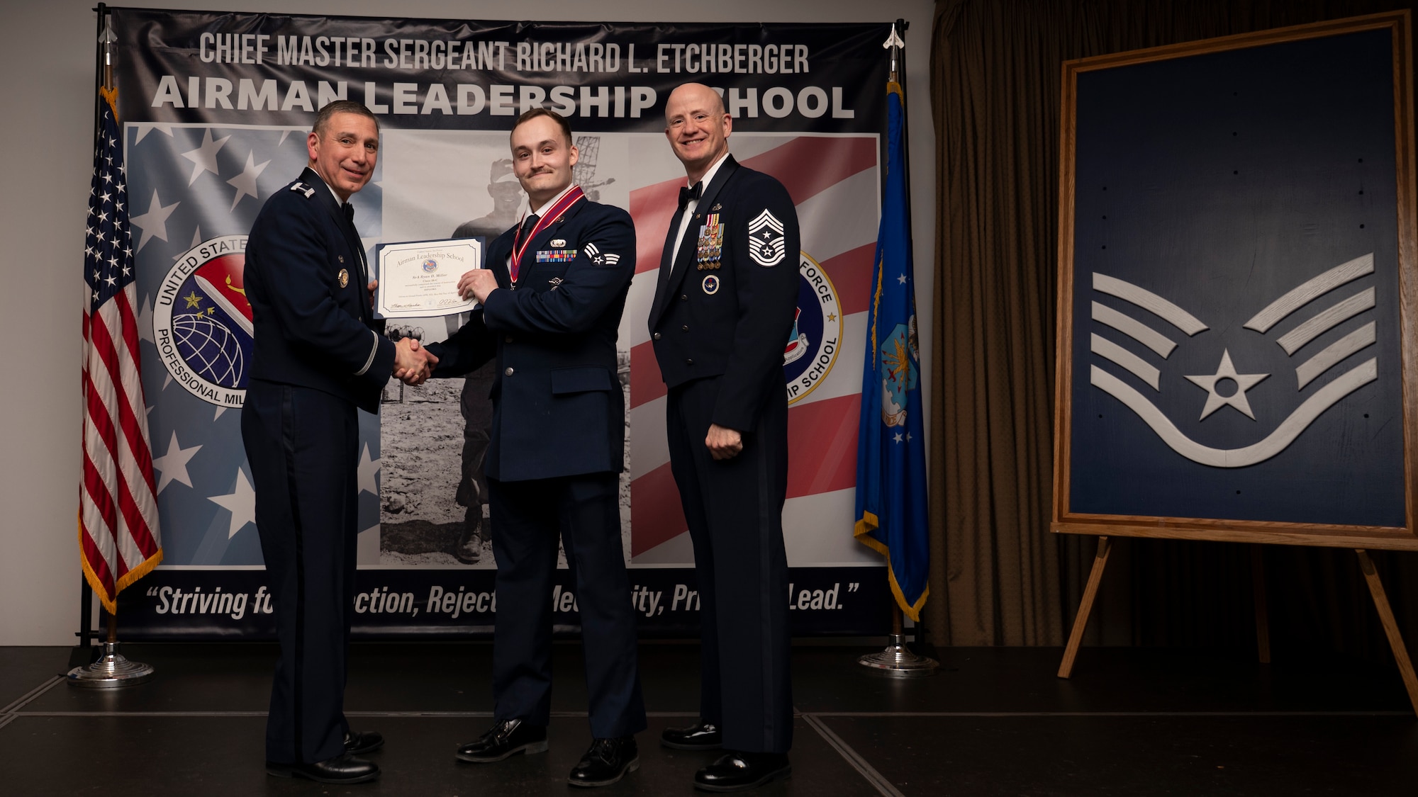 A photo of airmen posing with an award
