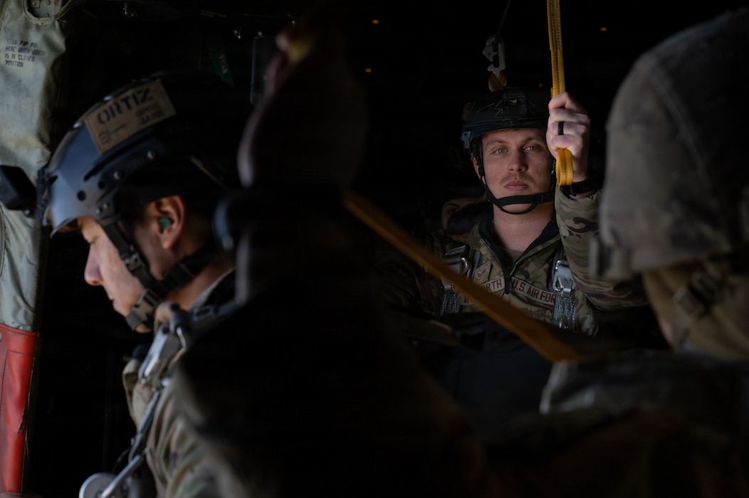Airmen prepare to jump out of a C-130J Super Hercules