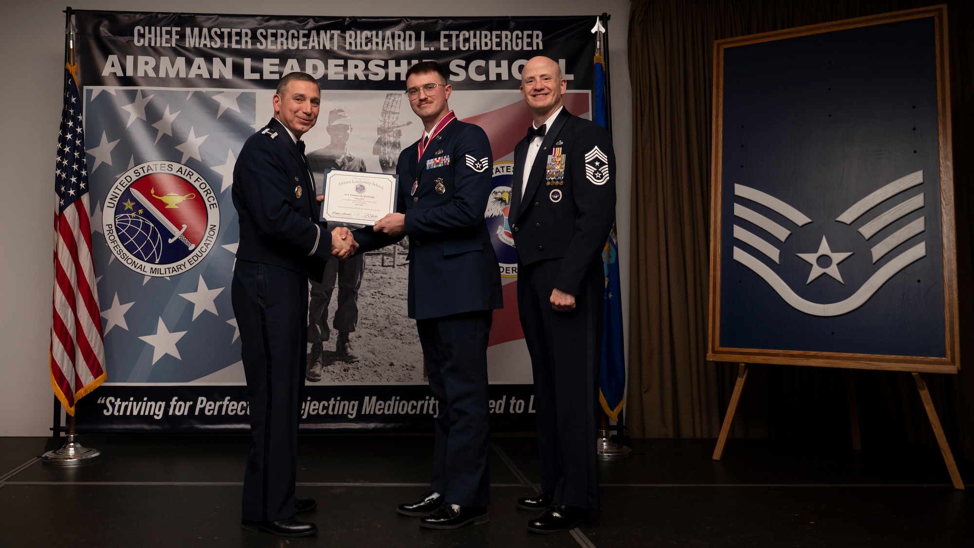 A photo of airmen posing with an award