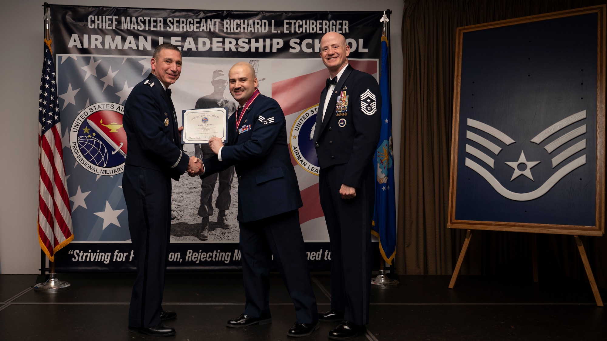 A photo of airmen posing with an award