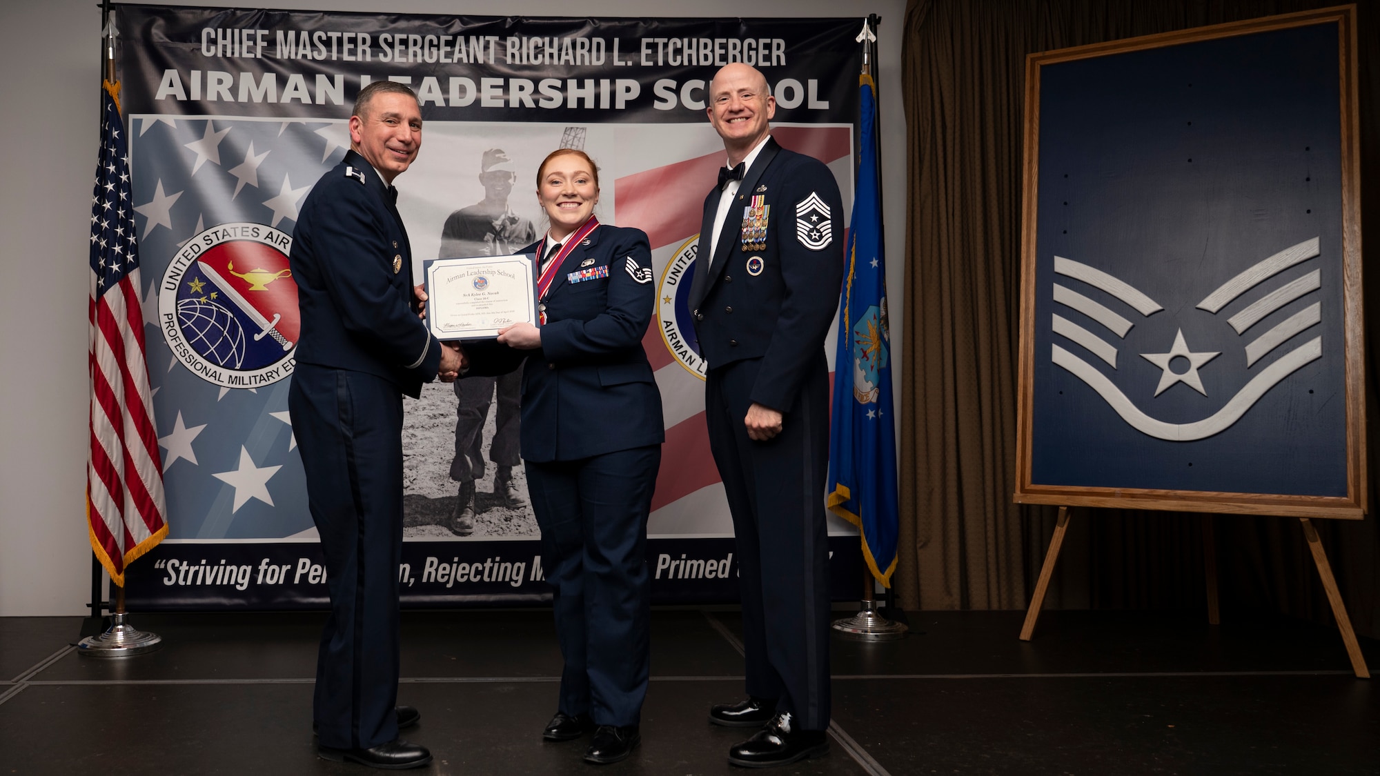 A photo of airmen posing with an award