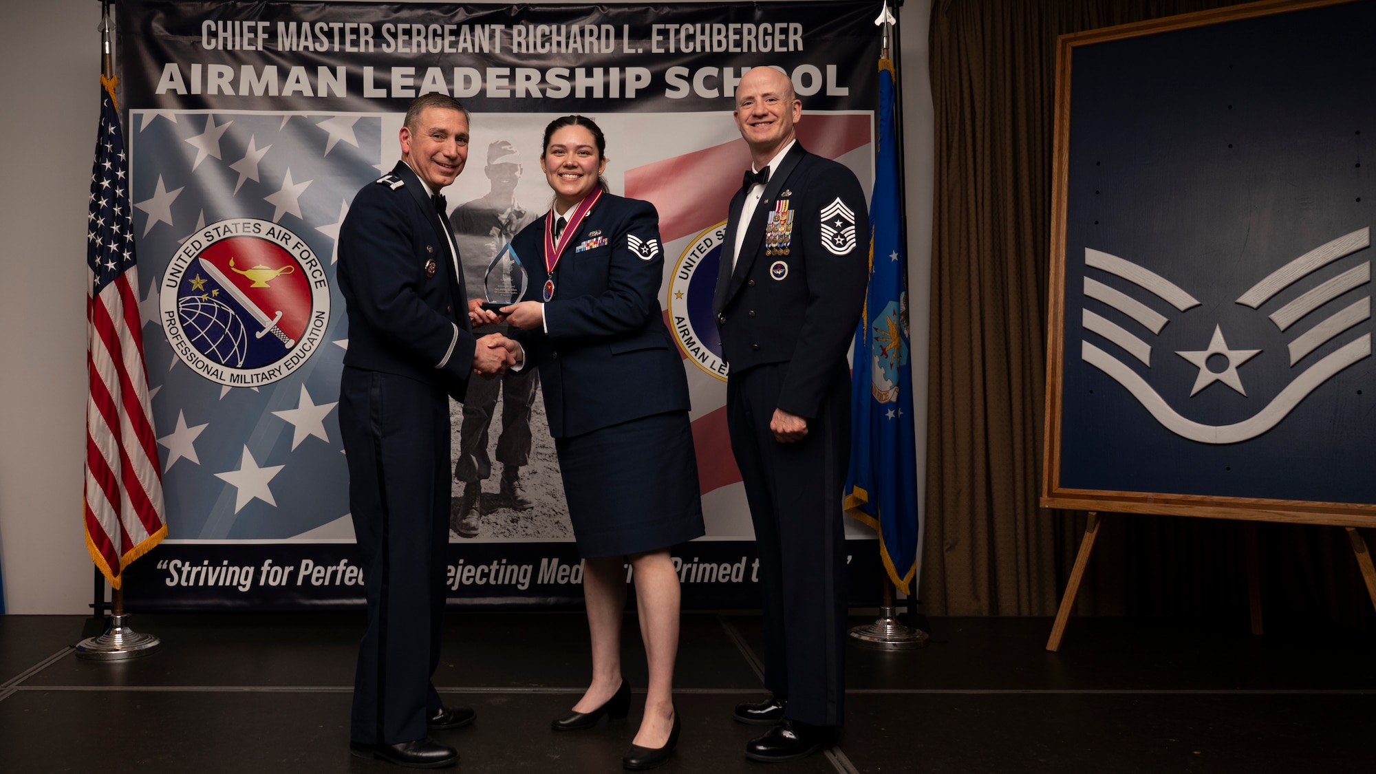 A photo of airmen posing with an award