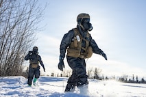U.S. Marine Corps Cpl. Camron Davis, right, and Cpl. Ian Dunbar, both chemical, biological, radiological and nuclear defense specialists assigned to the Chemical Biological Incident Response Force, execute reconnaissance to locate a target and identify a sample site while conducting cold weather sample training during ARCTIC EDGE 2026 (AE26) near Fort Greely, Alaska, March 5, 2026. AE26 is a North American Aerospace Defense Command (NORAD) and U.S. Northern Command-led homeland defense exercise designed to improve readiness, demonstrate capabilities, and enhance Joint and Allied Force interoperability in the Arctic. (U.S. Marine Corps photo by Lance Cpl. Amy Espinoza)