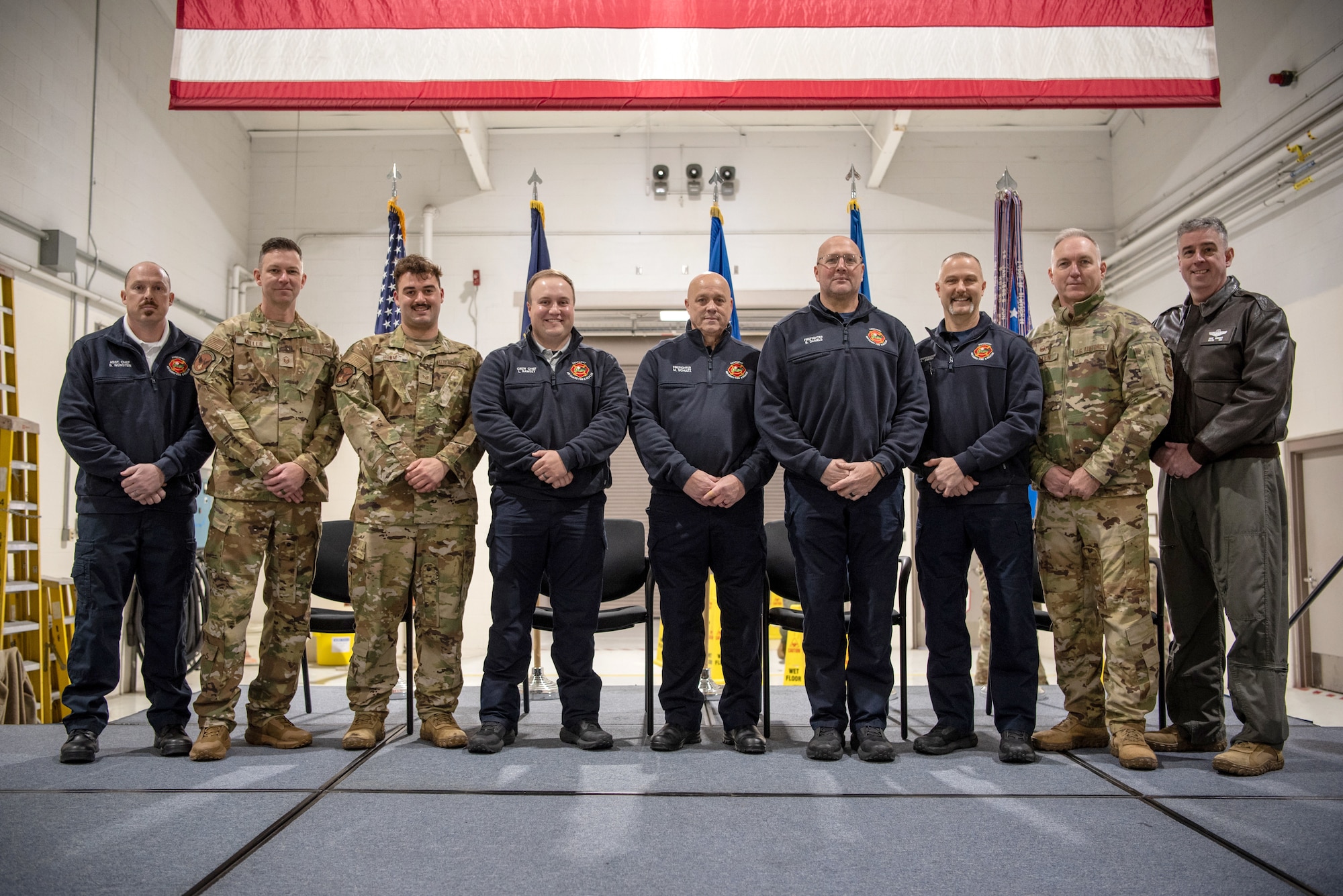 Eight firefighters from the 123rd Fire and Emergency Services Department are honored with Kentucky Distinguished Service Medals during a ceremony at the Kentucky Air National Guard Base in Louisville, Ky., Dec. 14, 2026, for their efforts in subduing a massive fire after a United Parcel Service cargo jet crashed near Louisville Muhammad Ali International Airport in November. Receiving the medal were (left to right) Assistant Fire Chiefs William Weinstein and Kyle Miller; Firefighter Ethan Howay; Crew Chief Logan Ramsey; and Firefighters Mark Shultz, William Daniels, Alan Smith and Robert Holmes (not pictured). Joining the firefighters for the ceremony were Fire Chief Ty Allen and Kentucky’s assistant adjutant general for Air, Birg. Gen. Bruce Bancroft. (U.S. Air National Guard photo by Master Sgt. Josh Horton)
