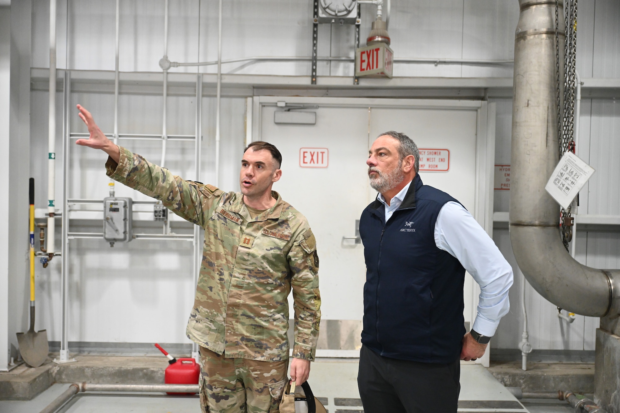 U.S Air Force Capt. Hunter Bergman, the 545th Airlift Squadron training lead, explains fuel capabilities to Terry Umatum, the recently-appointed port director of the Don Young Port of Alaska, on Joint Base Elmendorf-Richardson, Alaska, April 3, 2026. Bergman led Umatum through a tour of a fuels facility to give him a better understanding of the relationship between the port and JBER. (U.S. Air Force photo by Airman 1st Class Eli A. Rose)