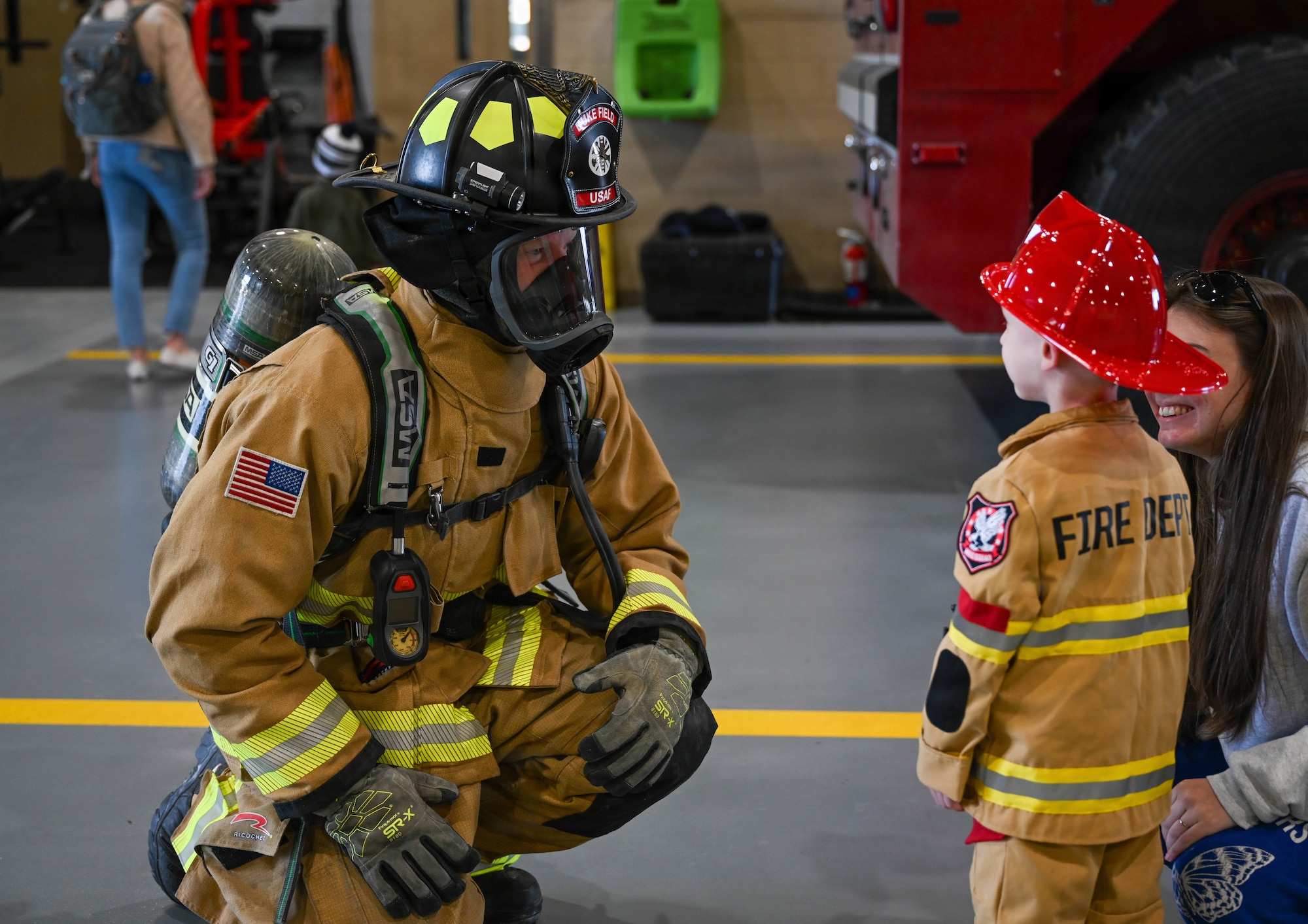 A firefighter talks to a child