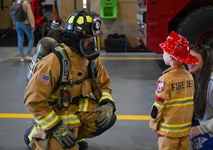 A firefighter talks to a child