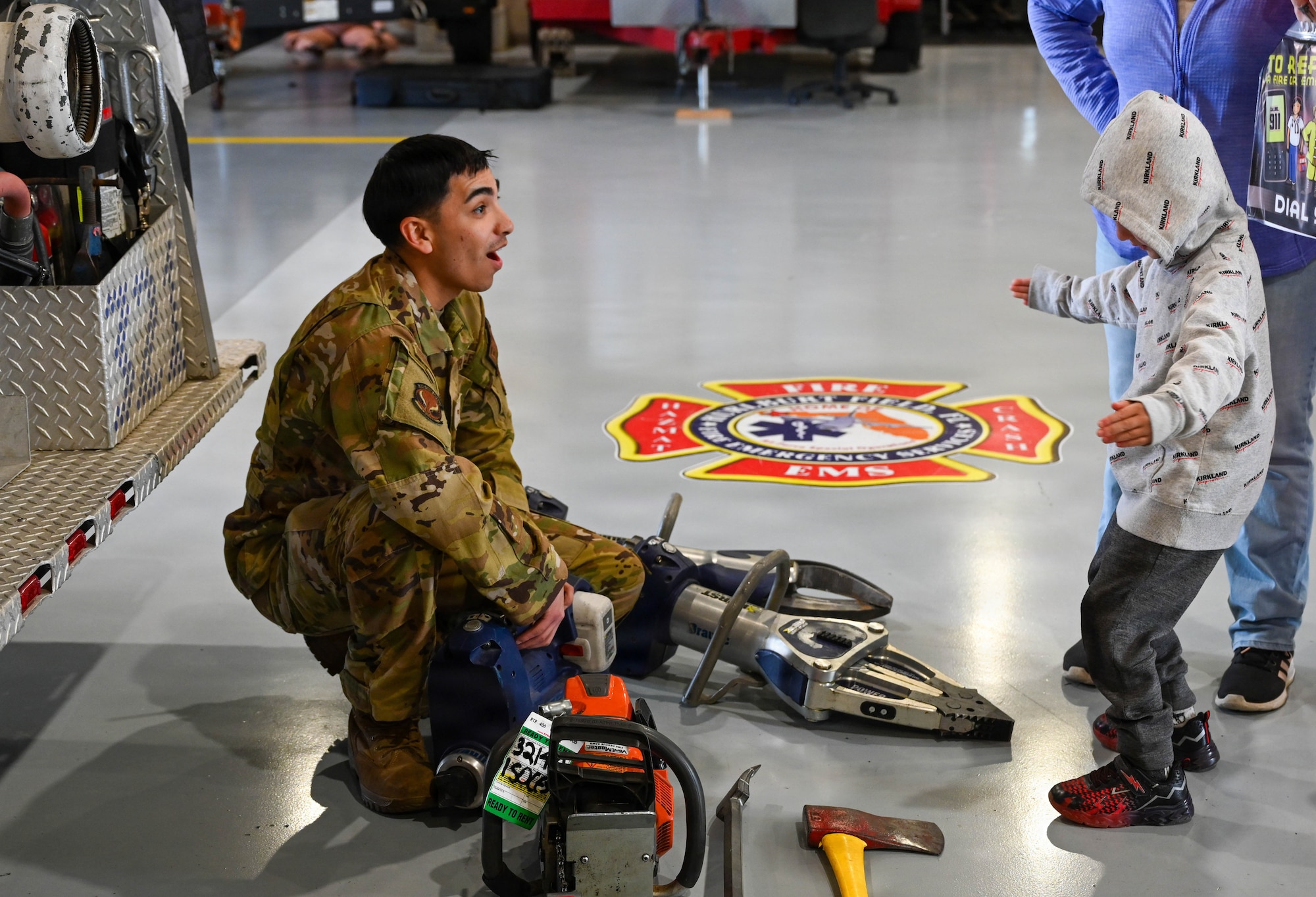 Firefighter shows a child firefighting equipment