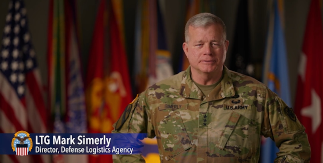 LTG Mark Simerly stands in front of American and military service flags, with a note in the bottom left corner labeled "LTG Mark Simerly, Director, Defense Logistics Agency" with the DLA emblem