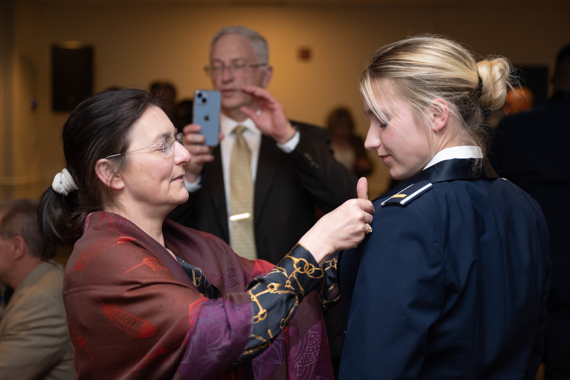 Loved ones pin silver wings on their graduate during a graduation ceremony of Class 26-08 at Laughlin Air Force Base, Texas, April. 9, 2026. Twenty-six U.S. and Hungarian Air Force officers were awarded the coveted silver wings for completing Undergraduate Pilot Training. (U.S. Air Force photo by Airman 1st Class Darryl Keith)