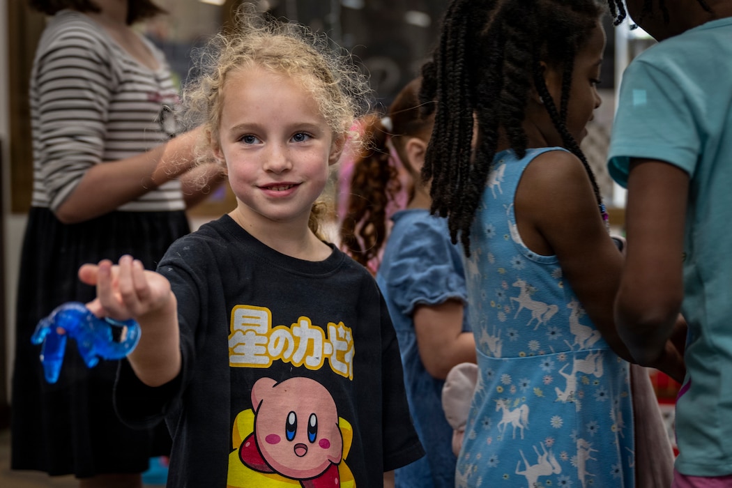 Kid shows off rubber toy to the camera.