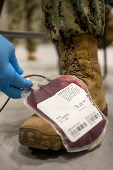 A whole blood collection and transfusion kit is set on the service members rocking foot to prevent coagulation during Operation Blue Horizon 2024 at MacDill Air Force Base, Florida, June 5, 2024