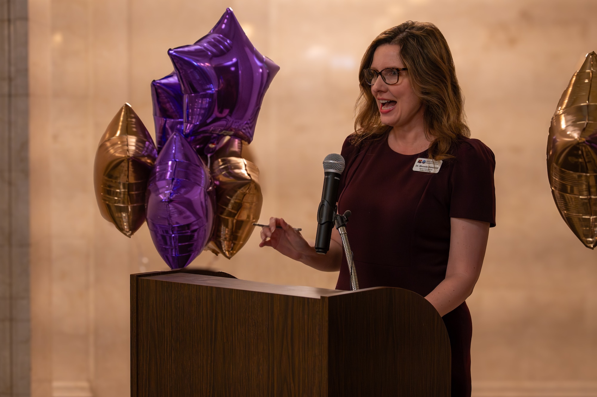 woman speaks at podium