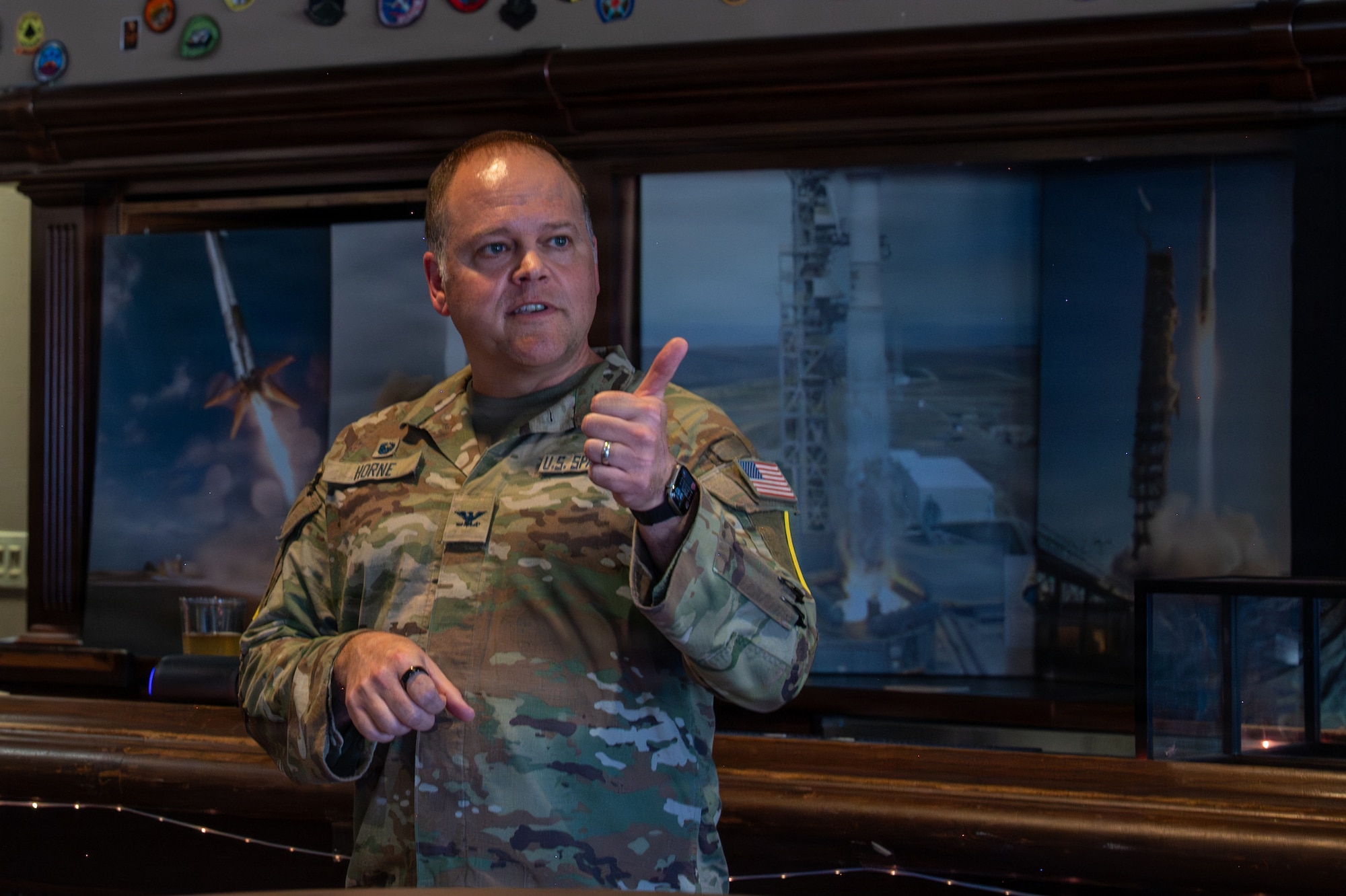 U.S. Space Force Col. James T. Horne III gives a thumbs up and motions to a crowd.