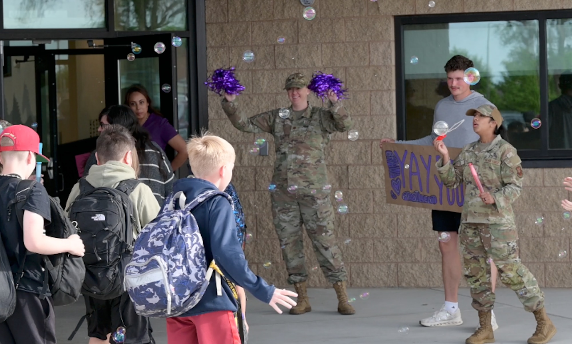 Students from Sandia Base Elementary School play with bubbles blown by service-members April 10 at Kirtland Air Force Base, New Mexico. The event was held as part of a month-long celebration honoring the unique sacrifices and adaptability of military children across the base. (U.S. Air Force photo by Airman Maurice Casilla)