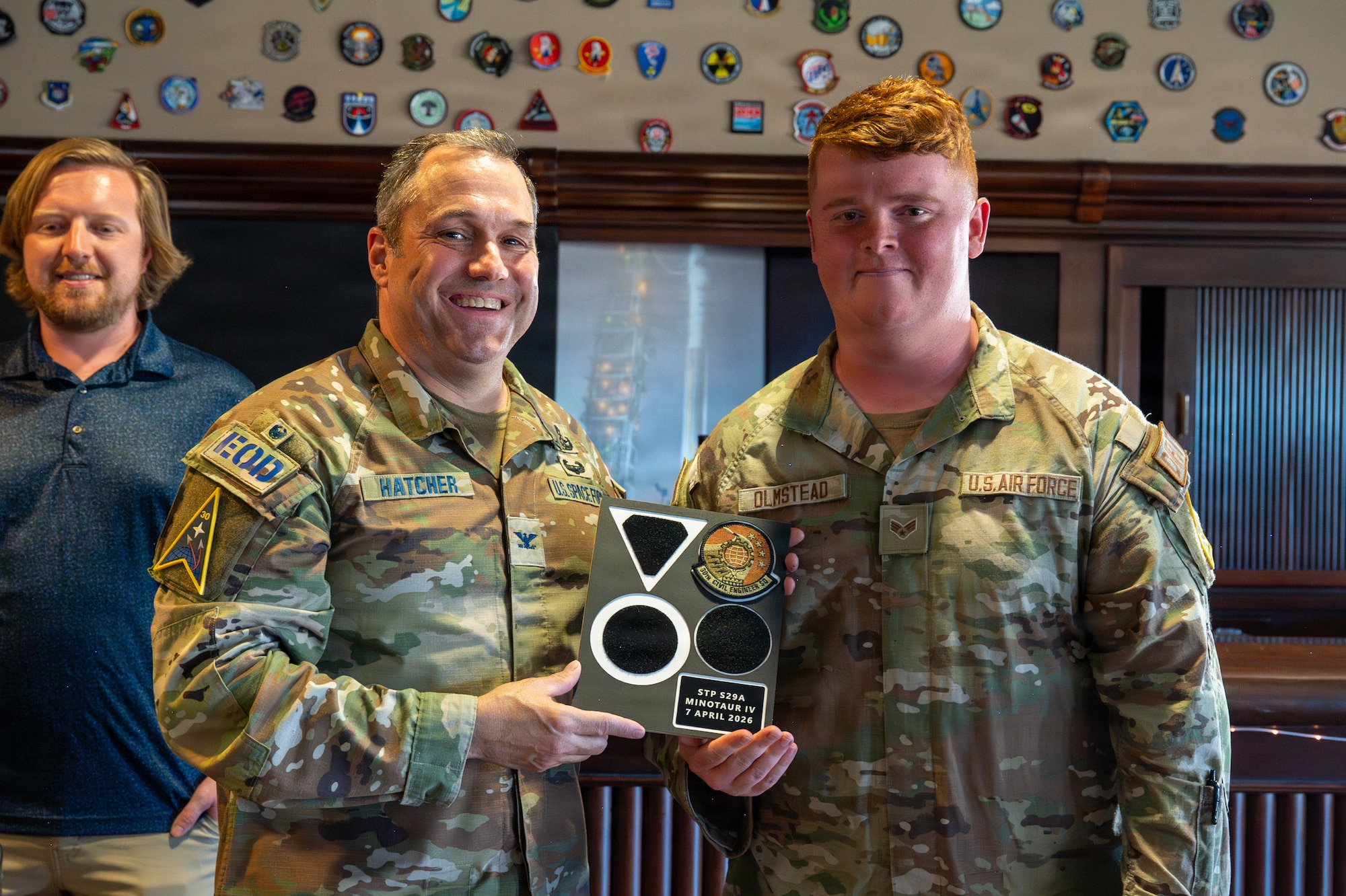 U.S. Space Force Col. Dorian Hatcher and U.S. Air Force Senior Airman Kyle Olmstead smile for a photo.