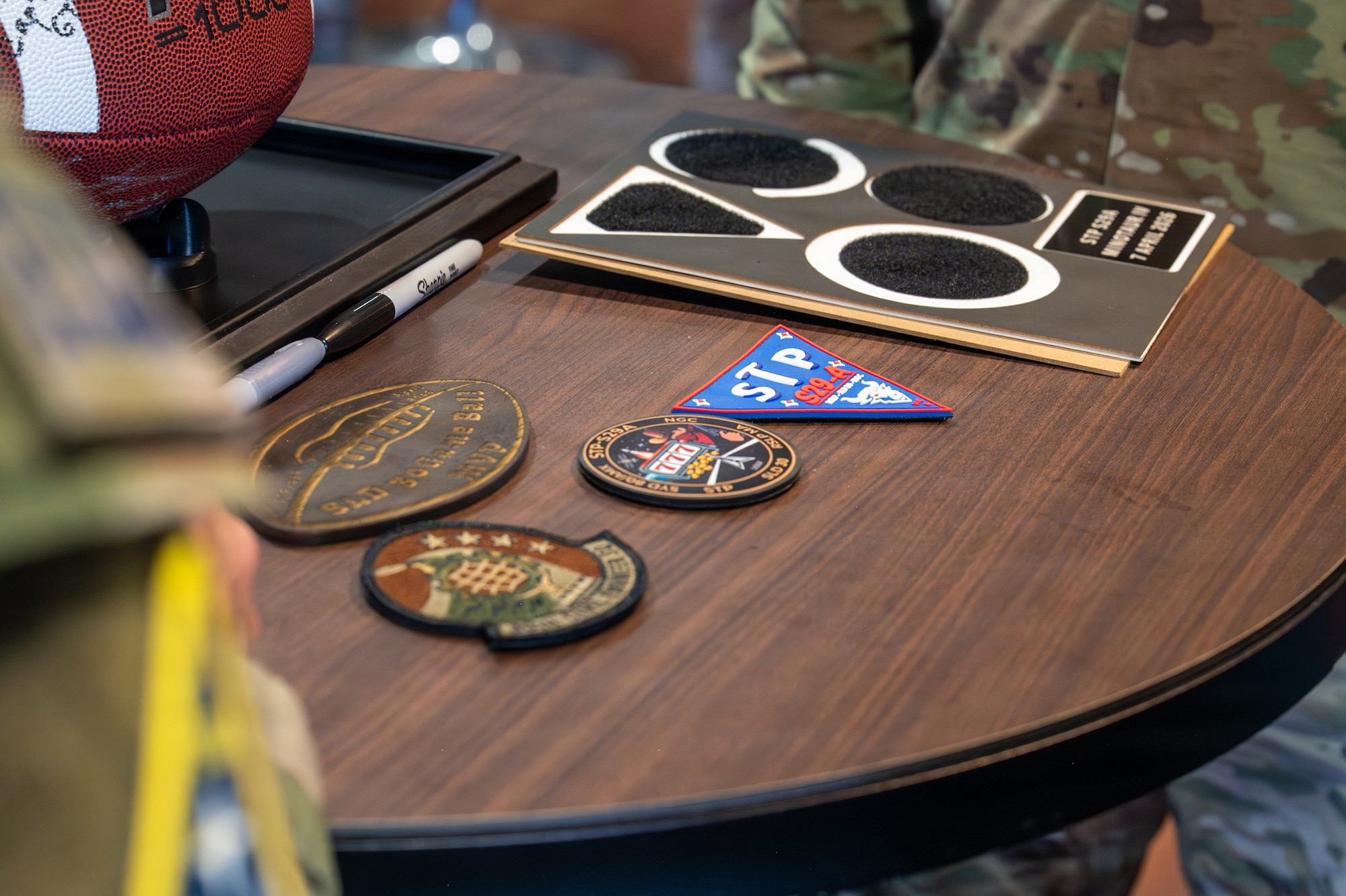 Unit patches are laid out on a table.