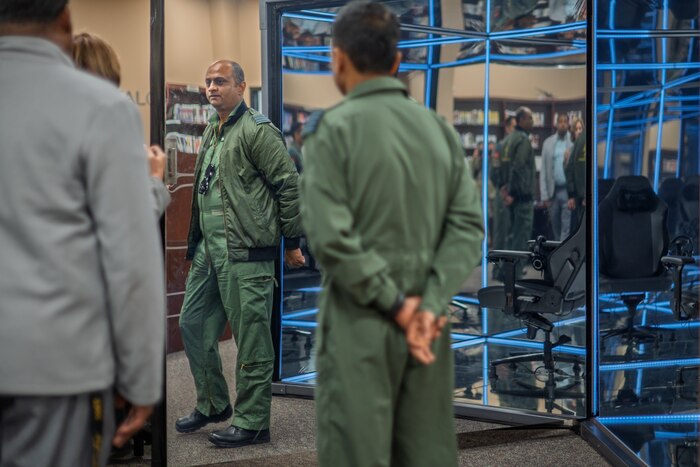 Members from the Indian Air Force stand in a room during a tour of Air University Library.