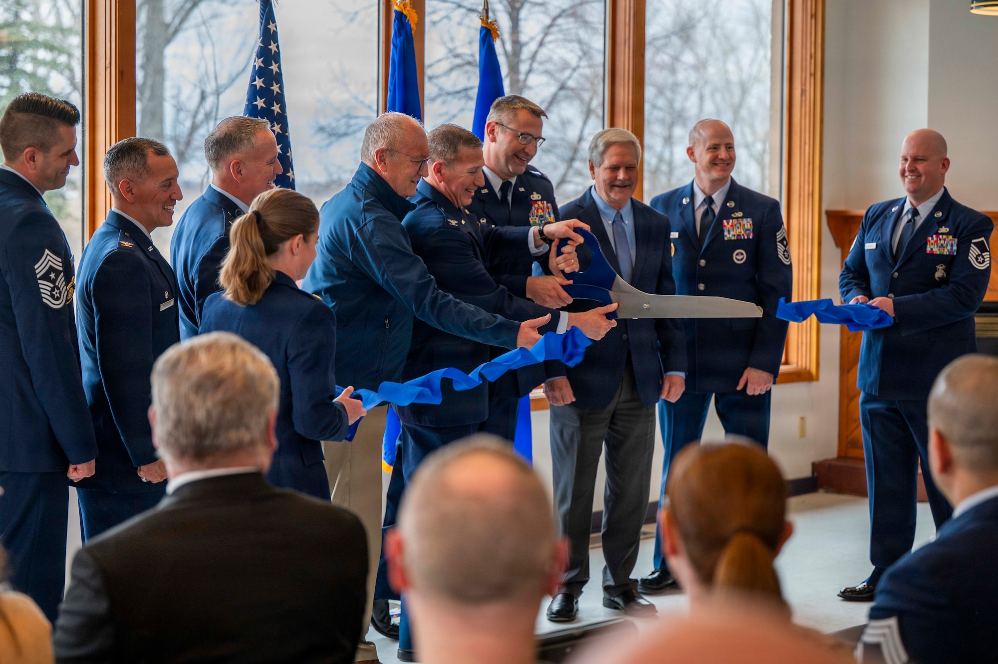 From left, Chief Master Sgt. Stephen Vogt, 184th Wing Kansas Air National Guard command chief; Col. Alfred Rosales, 319th Reconnaissance Wing commander; Brig. Gen. Micah Fesler, Air National Guard advisor to the commander, Air Combat Command; Maj. Ashlee Ellis, Point Defense Battle Lab director of operations; Sen. Kevin Cramer, R-N.D.; Col. Reynaldo Champion, PDBL director; Sen. John Hoeven, R-N.D.; Col. Joseph Deeds, 184th WG, Kansas ANG commander; Chief Master Sgt. William Gruenes, 319th RW command chief and Master Sgt. John Marshik, PDBL Senior Enlisted Leader; cut a ribbon during a PDBL ribbon cutting ceremony at Grand Forks Air Force Base, North Dakota, April 9, 2026.