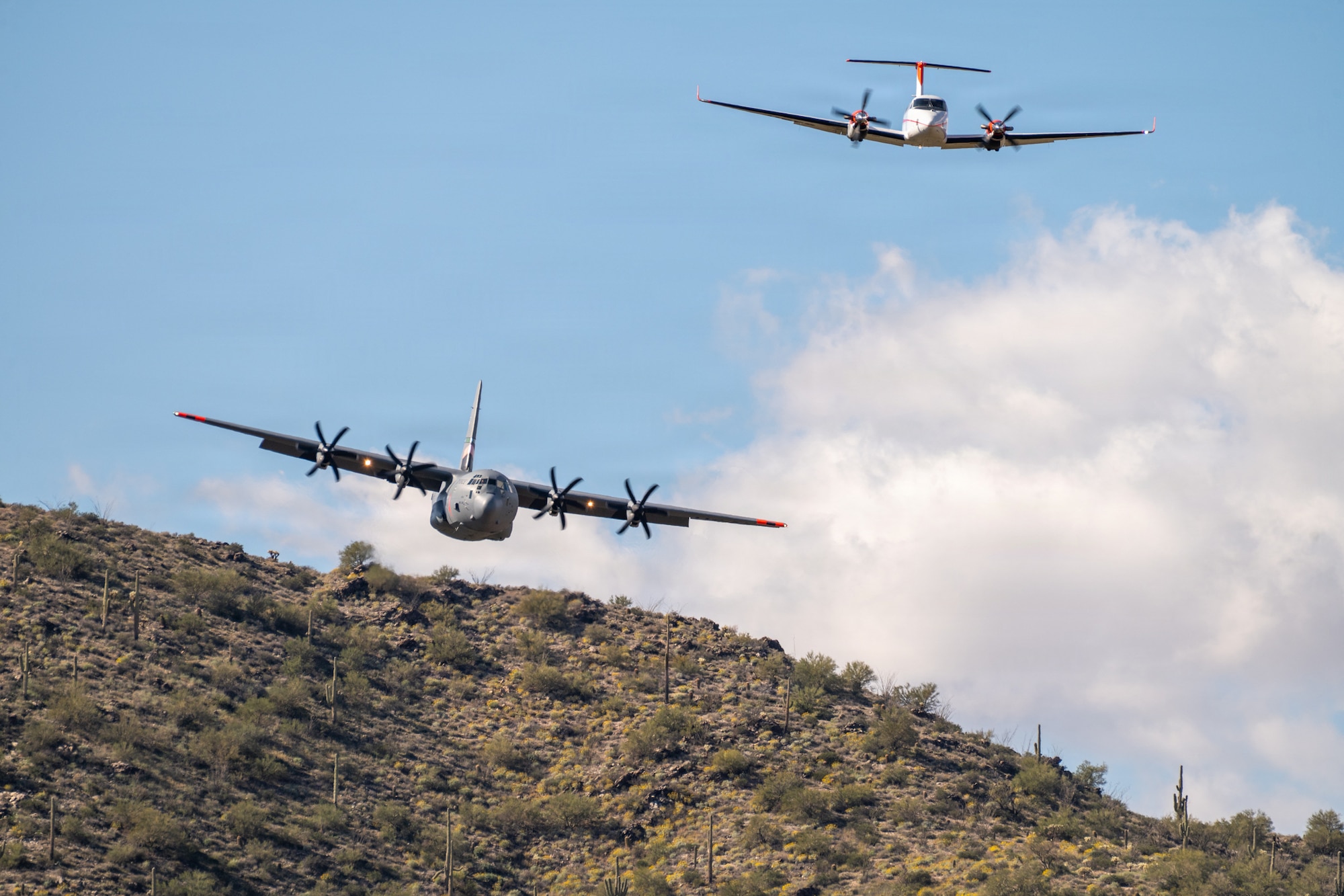 A U.S. Air Force C-130 Hercules equipped with the Modular Airborne Fire Fighting System (MAFFS) releases a plume of water during training at Libby Army Airfield, Fort Huachuca, Arizona, Feb. 11–21, alongside the U.S. Forest Service’s National Aerial Supervision Training Academy (NASTA).
