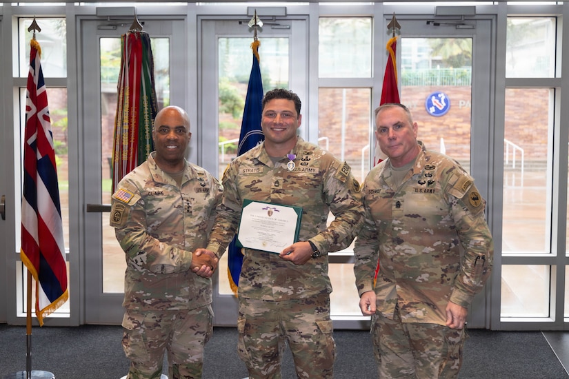 U.S. Army Sergeant First Class Ryan Stratis, U.S. Army Pacific, Explosive Ordinance Disposal (EOD) Plans and analysis NCO, (Center), Gen. Ronald P. Clark, USARPAC, Commanding General, (Left), Command Sgt. Maj. Jason Schmidt, USARPAC, Command Senior Enlisted Advisor, (Right), are photographed at Fort Shafter, Hawaii, Apr. 10, 2026.