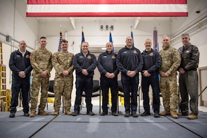 Eight firefighters from the 123rd Fire and Emergency Services Department are honored with Kentucky Distinguished Service Medals during a ceremony at the Kentucky Air National Guard Base in Louisville, Ky., Dec. 14, 2026, for their efforts in subduing a massive fire after a United Parcel Service cargo jet crashed near Louisville Muhammad Ali International Airport in November. Receiving the medal were (left to right) Assistant Fire Chiefs William Weinstein and Kyle Miller; Firefighter Ethan Howay; Crew Chief Logan Ramsey; and Firefighters Mark Shultz, William Daniels, Alan Smith and Robert Holmes (not pictured). Joining the firefighters for the ceremony were Fire Chief Ty Allen and Kentucky’s assistant adjutant general for Air, Birg. Gen. Bruce Bancroft. (U.S. Air National Guard photo by Master Sgt. Josh Horton)