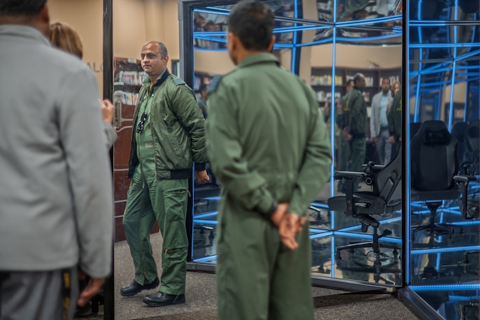 Members from the Indian Air Force stand in a room during a tour of Air University Library.