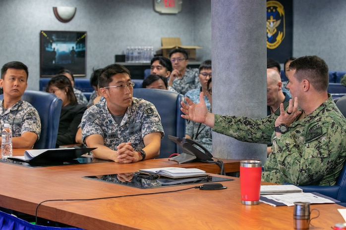 Capt. John P. Baggett, commodore of Destroyer Squadron 7 speaks with LTC Ivan Kwah, assigned to HD Intel Branch, HQ Fleet, Republic of Singapore Navy during staff talks aboard the U.S. 7th Fleet flagship USS Blue Ridge (LCC 19) as part of a scheduled port visit to RSS Singapura – Changi Naval Base, Singapore, April 6, 2026.