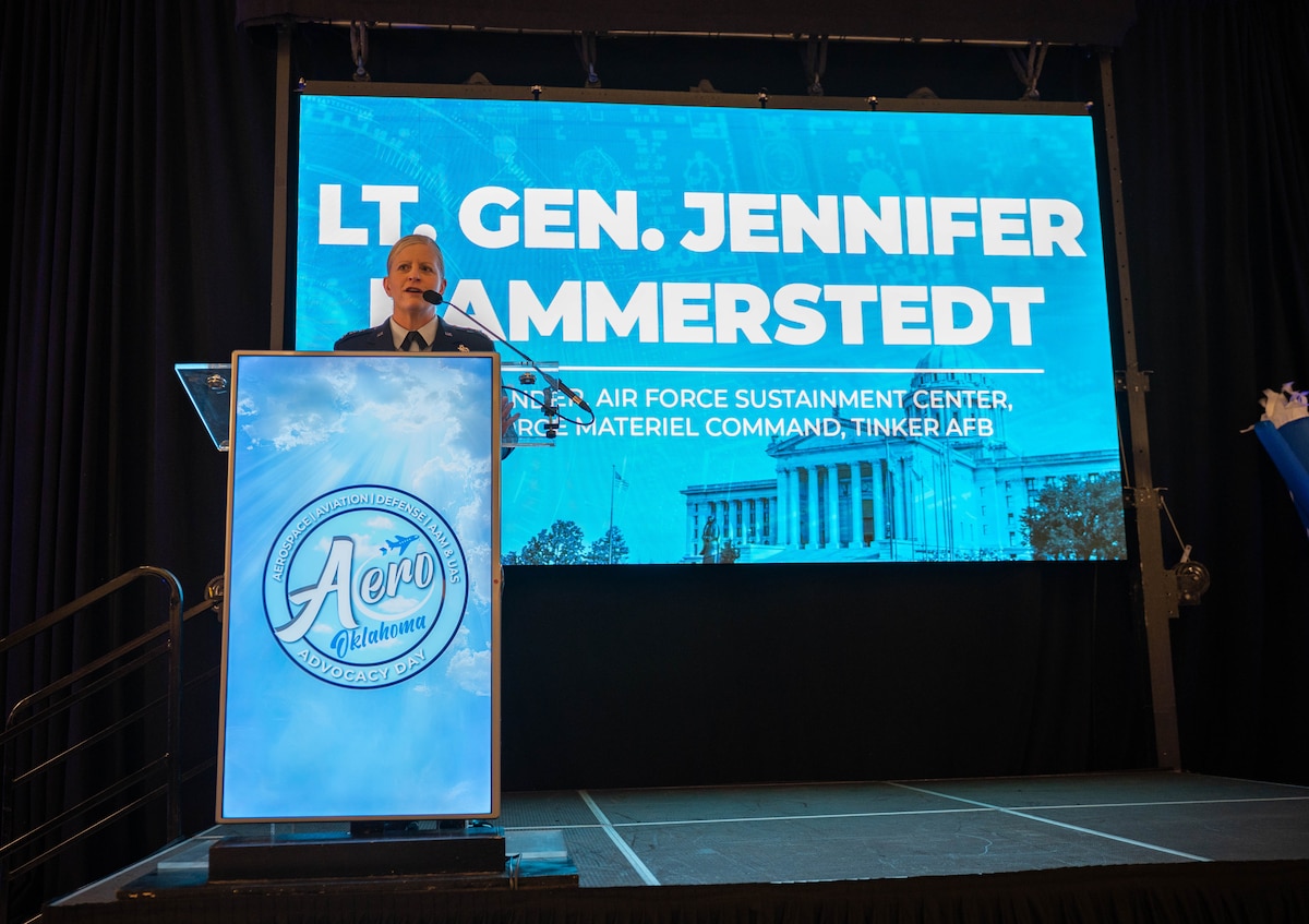 Air Force General in front of screen with her name