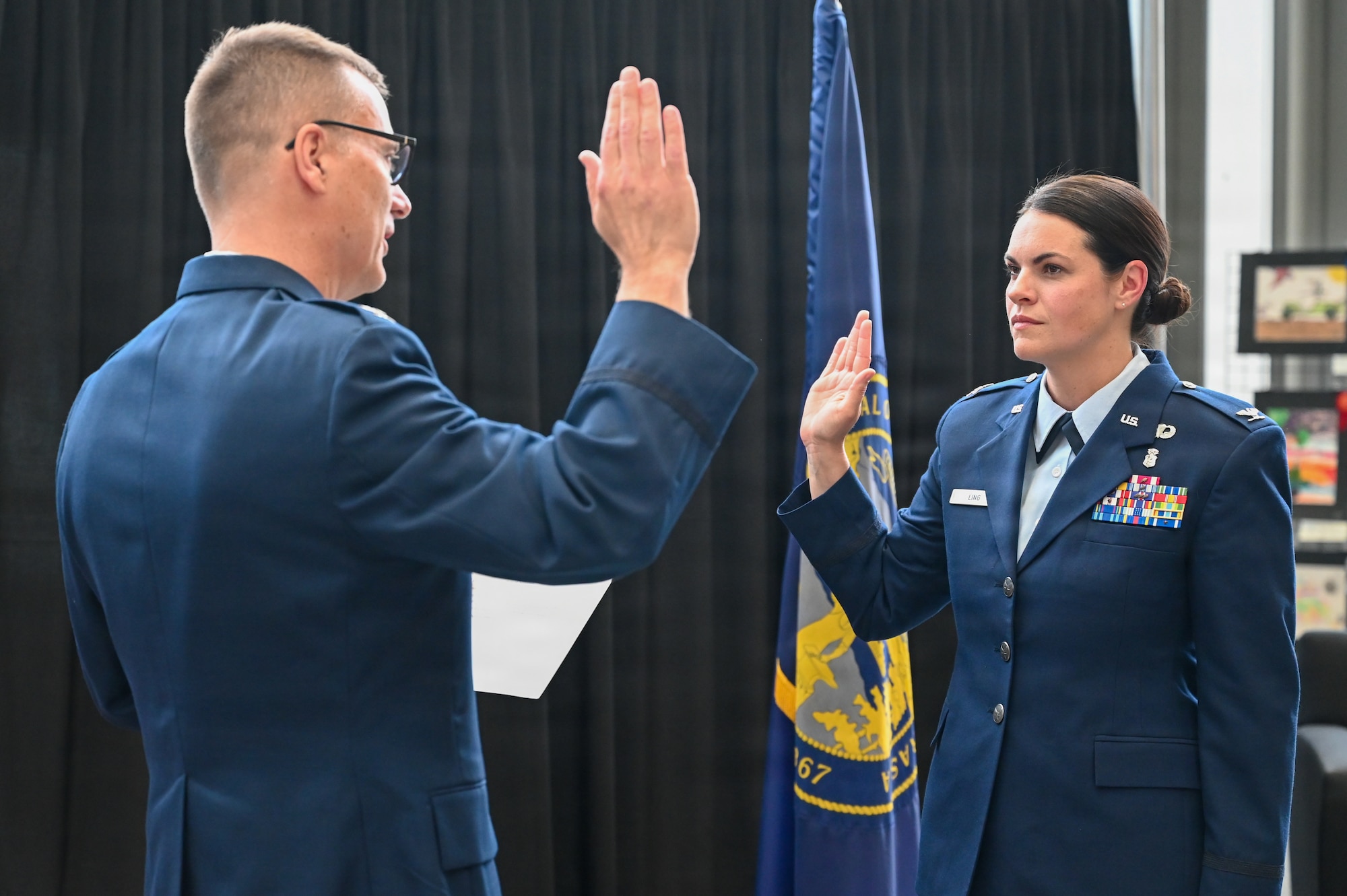 Col. Brooke Sciuto, outgoing 155th Medical Group commander, salutes Col. Christopher Hesse, 155th Air Refueling Wing commander, at her change of command ceremony, April 11, 2026, at the Nebraska National Guard air base in Lincoln, Nebraska. Sciuto thanked Hesse for his leadership and friendship over the past four years. (U.S. Air National Guard photo by Tech. Sgt. Phil Cowen)